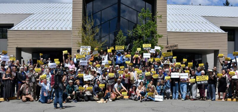 Group photo of Community Environmental Advocates carrying protest signs