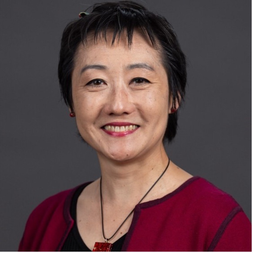 Headshot of smiling woman with short dark hair.