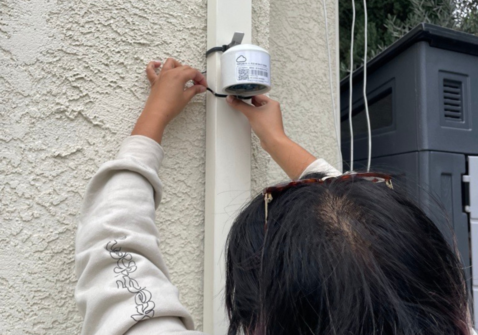 NVR staff installing PurpleAir Monitor.