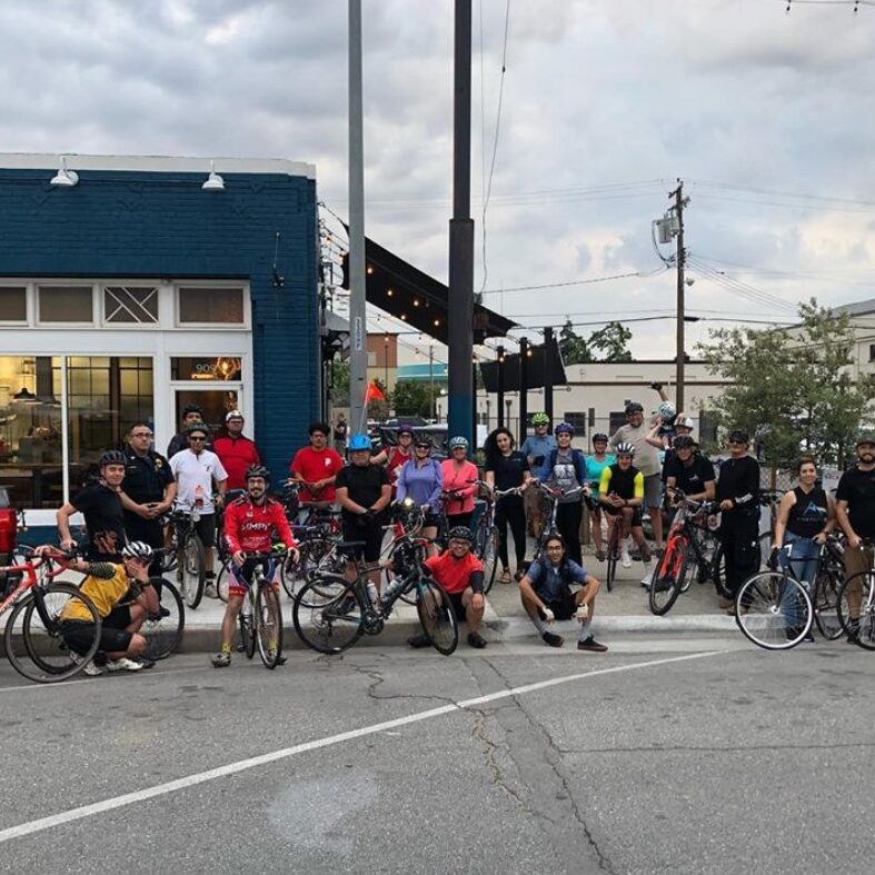 A group of bikers smiling.